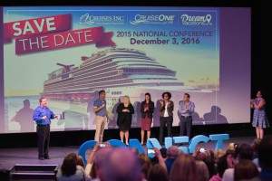 Group of people on stage with a slideshow showing cruise ship.