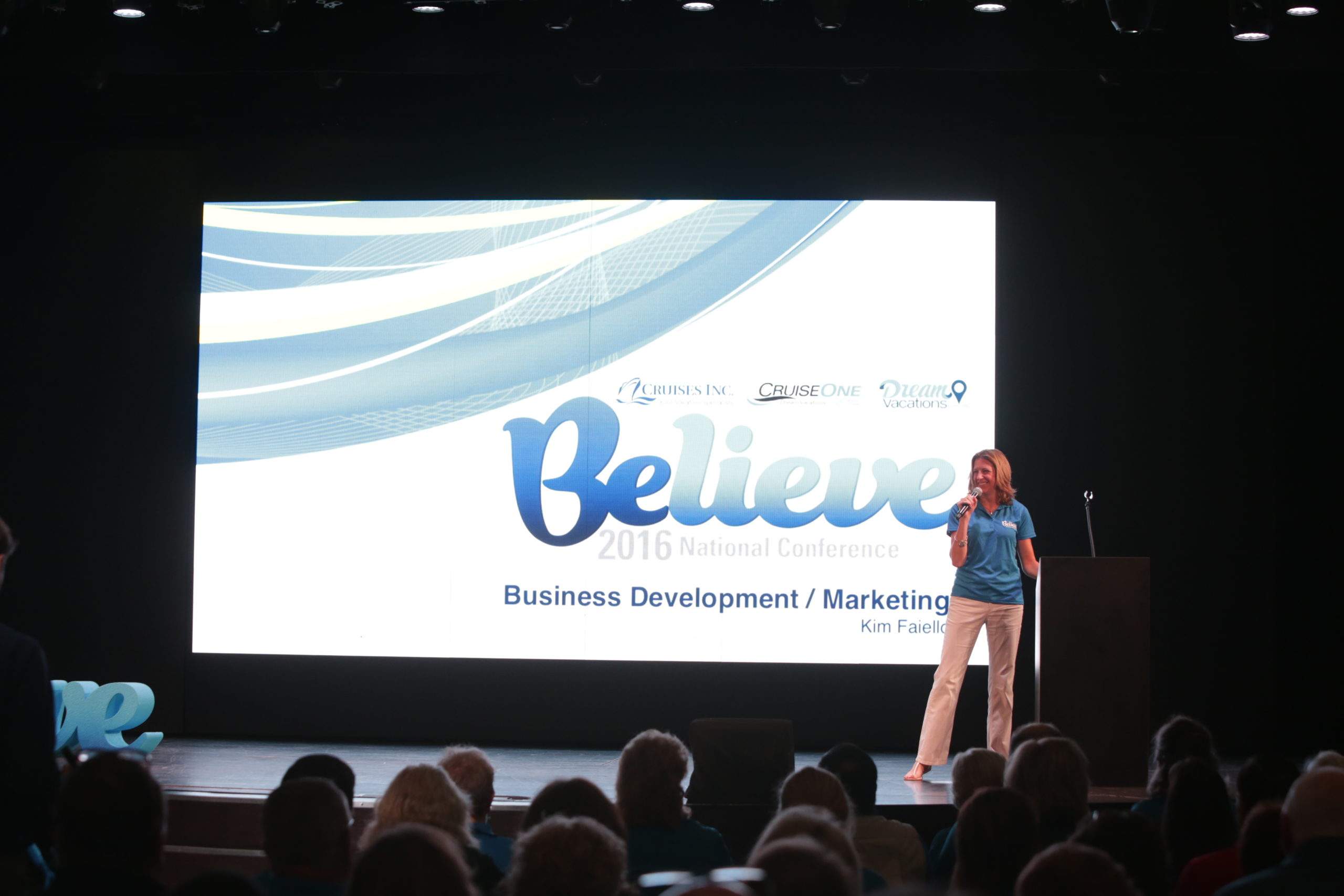 A woman presenting on stage at Believe 2016 National Conference.