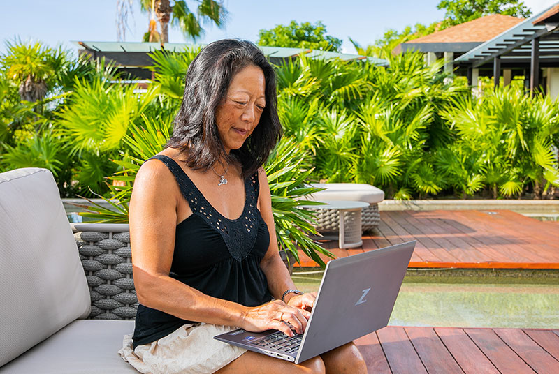 Dream Vacation franchisee at a resort on her computer