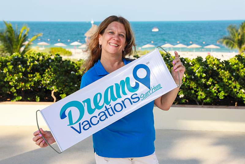 Franchisee holding up Dream Vacations sign