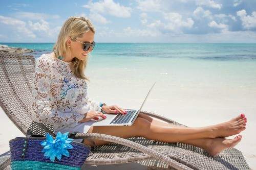 travel agent working on the computer at the beach