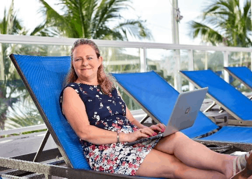 Dream Vacations Franchisee Owner Working poolside from her laptop