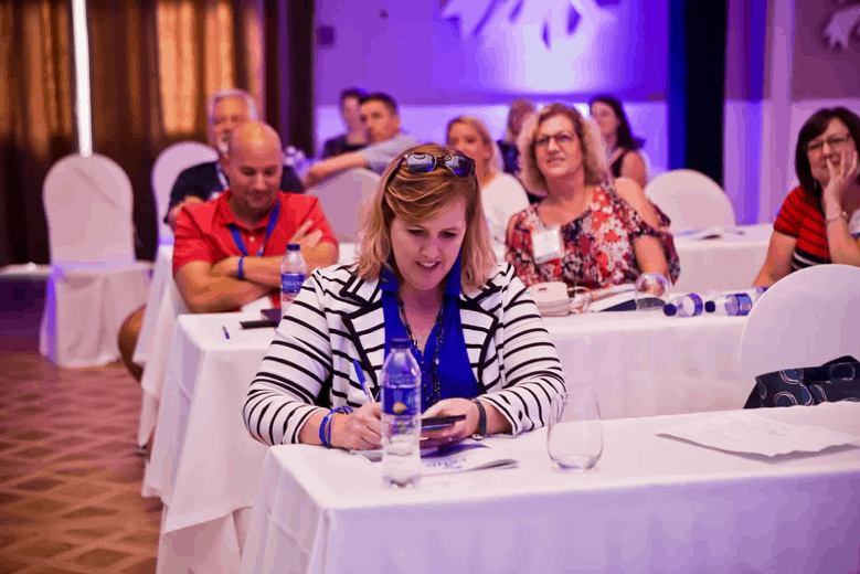 How does Dream Vacations Franchise work? Franchisees take notes at a regional training summit