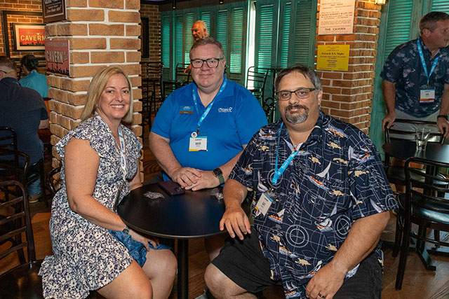 three Dream Vacations travel agents sitting at a table