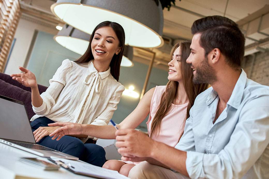 Woman showing couple travel plans on her laptop - learn how to get into the travel industry