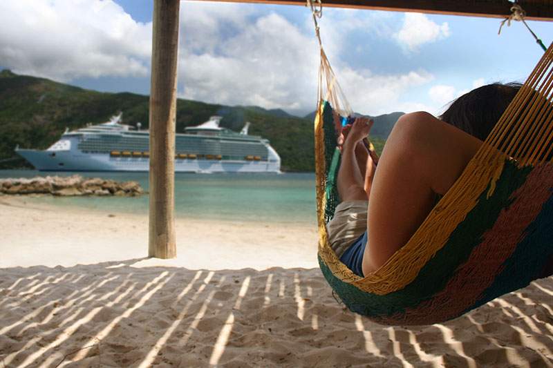 Woman in hammock looking out at the ocean - learn how to start a cruise travel agency