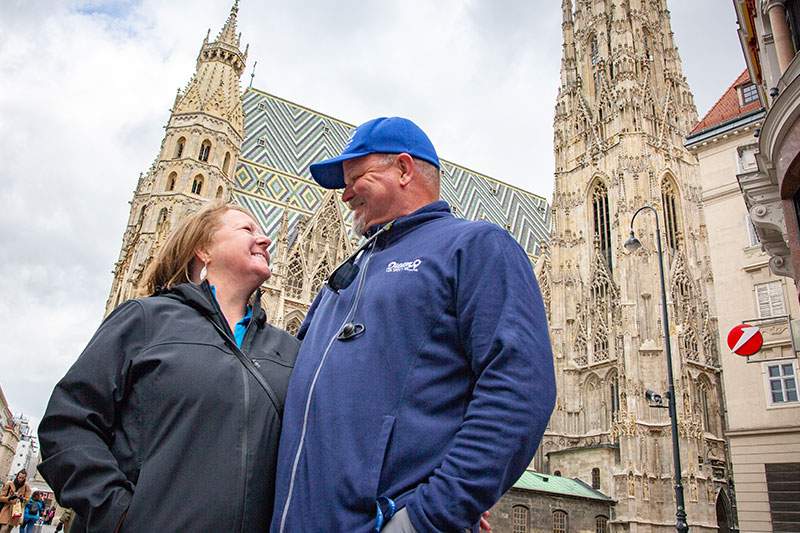 man and woman looking at each other in front of a cathedral - veteran franchises under 10k