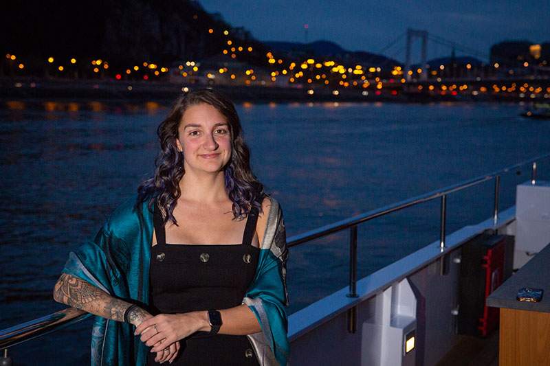 Dream Vacation Franchisee on a deck of a boat overlooking a nighttime view
