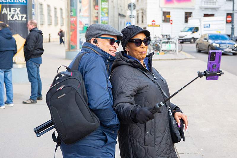 man and woman taking a picture with a selfie stick - tourism franchise opportunities