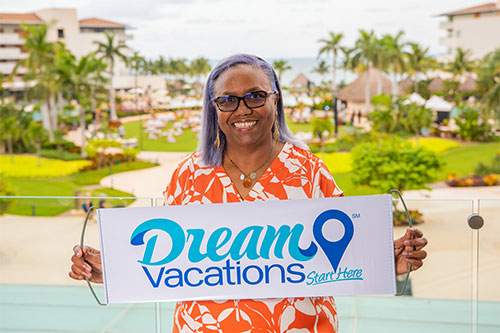Dream Vacations franchisee holding up a company sign