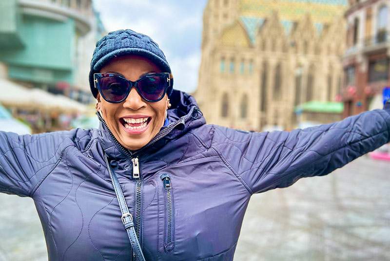 Dream Vacation travel agent with her arms stretched out