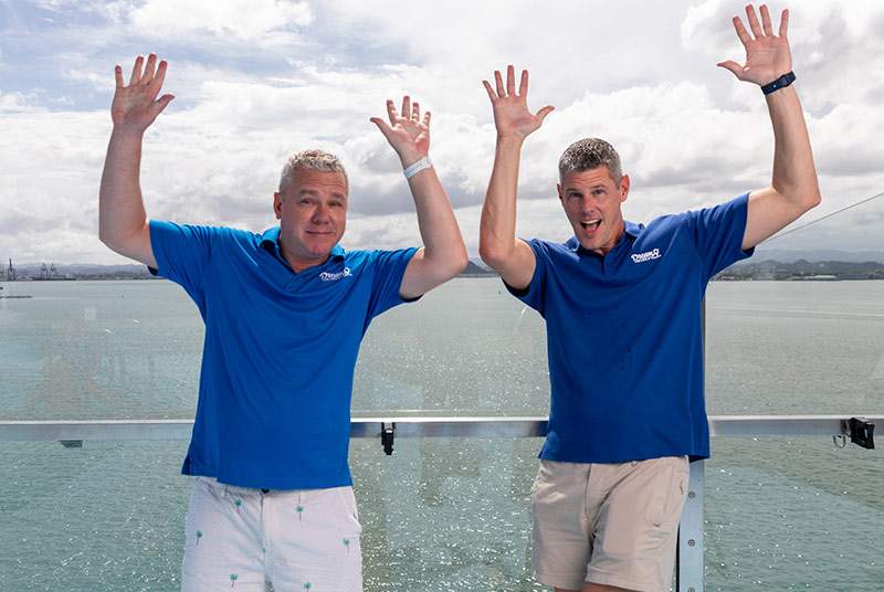 Dream Vacation franchisee's with their hands up on a boat