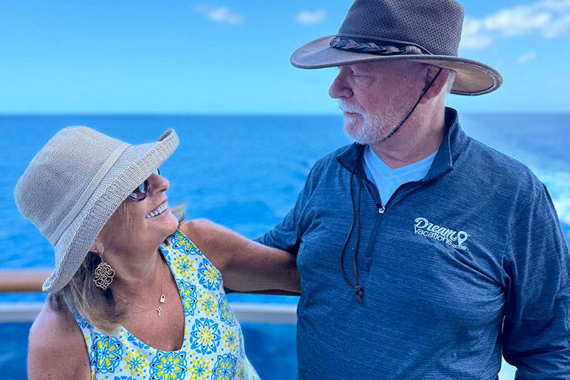 and older couple looking at each other on a ship balcony