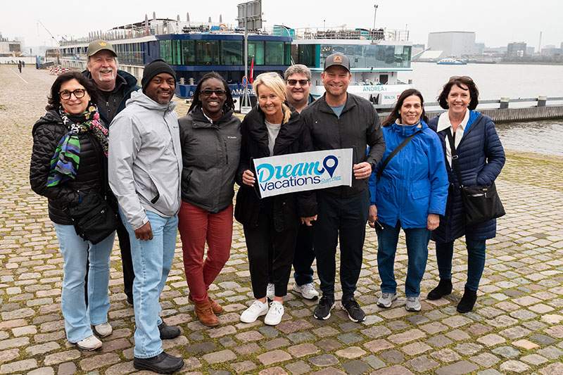 group of franchises holding a dream vacation sign