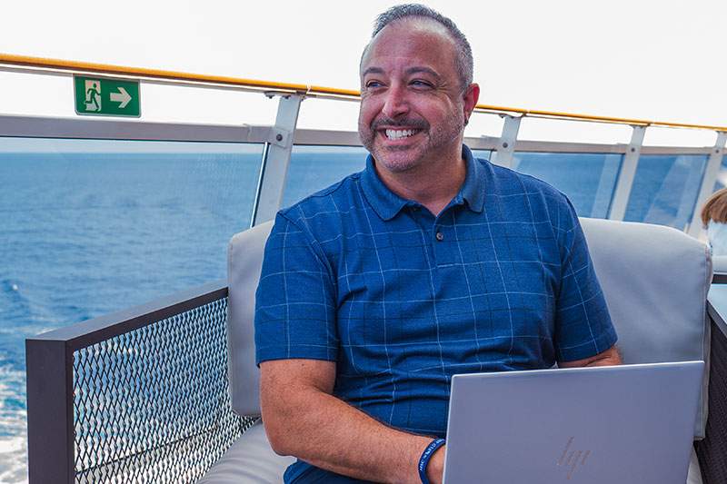man on a boat with his laptop out