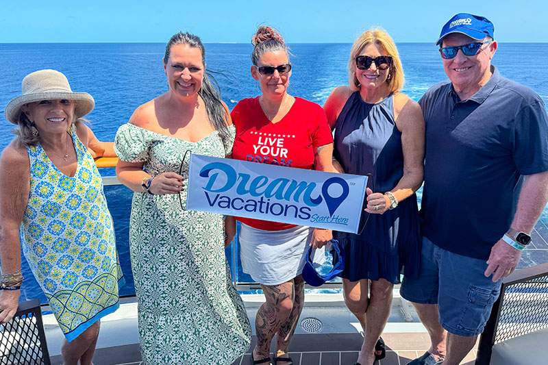 group of people with a Dream Vacations sign