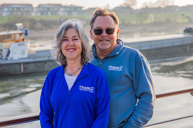 Man and woman Franchise Owners standing on river cruise deck
