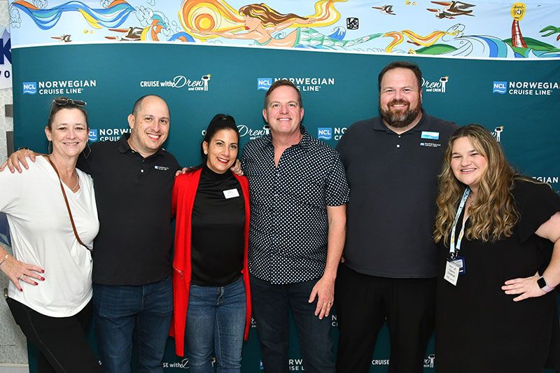 A group of people smiling and posing together.